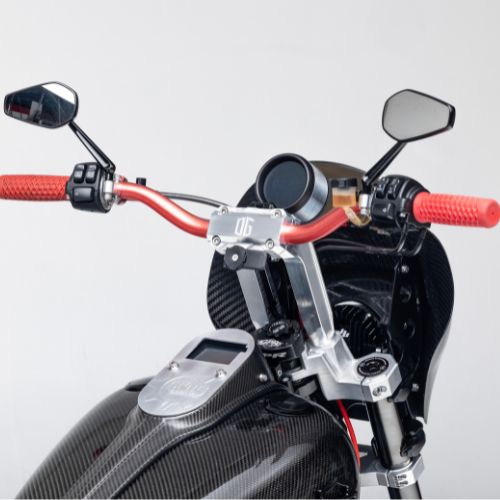 8.5-inch pull-back handlebar risers with red grips on carbon-fiber scooter