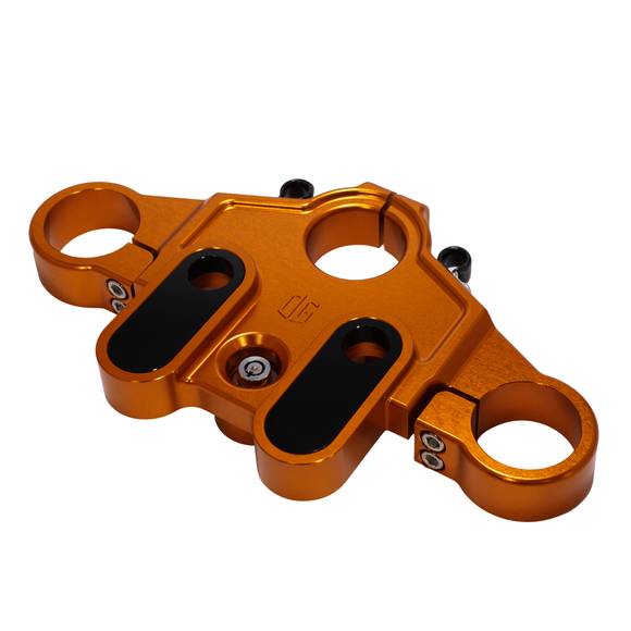 Orange anodized top triple tree clamp for touring motorcycles