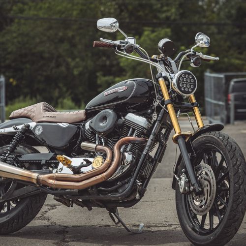 OG Points cover on black Harley Sportster motorcycle with copper exhaust