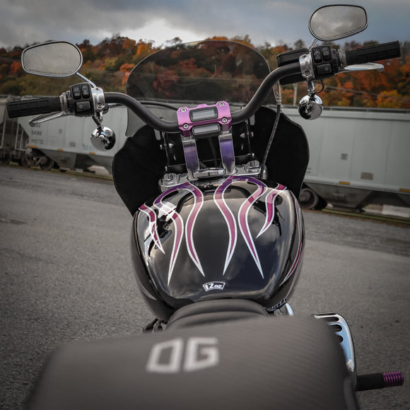 Black cruiser motorcycle tank with purple flame graphics and purple handlebar riser