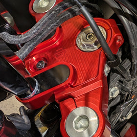 Red anodized CNC motorcycle top triple clamp close-up