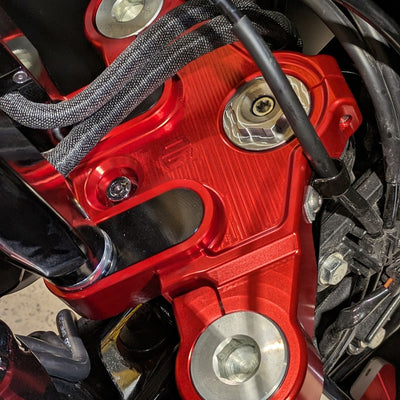 Red anodized CNC motorcycle top triple clamp close-up