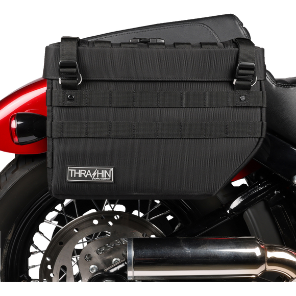 Thrashin Supply Co. Expedition Saddlebags in black ballistic nylon with MOLLE attachments and metal g-hook lids for Harley-Davidson Softail, Dyna, and FXR models