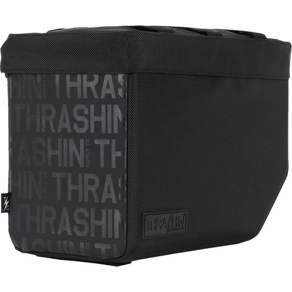 Thrashin Supply Co. Essential Saddlebags 10-liter in black ballistic nylon with MOLLE lid attachment points and hi-viz orange interior