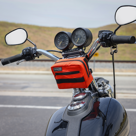 Thrashin Supply Co. ballistic nylon handlebar bag with YKK zippers and quick-attach straps mounted on Harley-Davidson handlebars