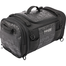 Thrashin Supply Co. Passenger Bag in black ballistic nylon with expandable dual-zipper design and hi-viz orange interior