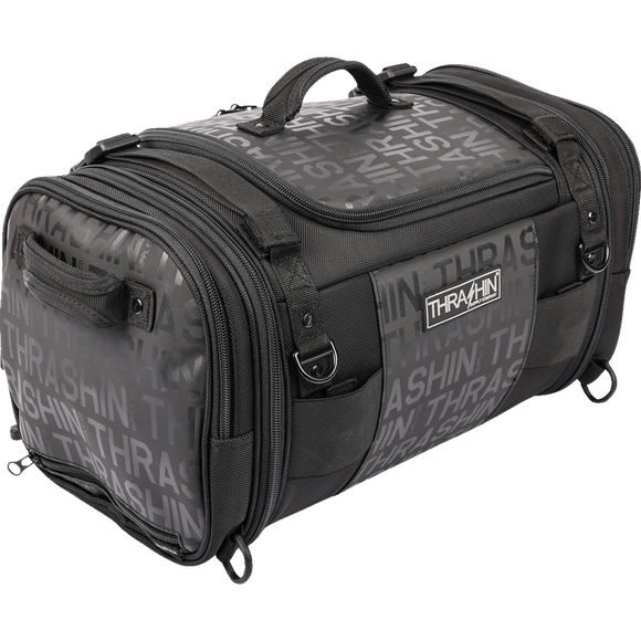 Thrashin Supply Co. Passenger Bag in black ballistic nylon with expandable dual-zipper design and hi-viz orange interior