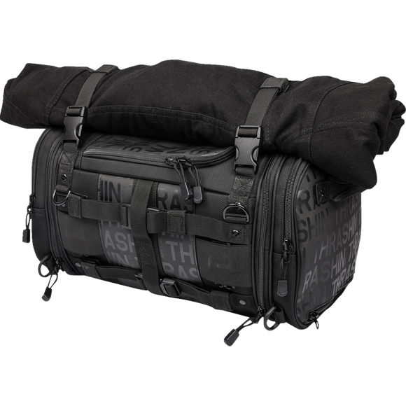 Thrashin Supply Co. Passenger Bag in black ballistic nylon with expandable dual-zipper design and hi-viz orange interior