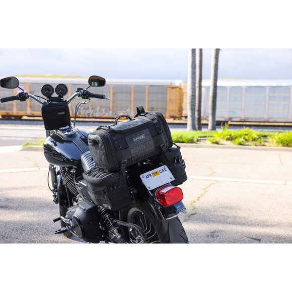 Thrashin Supply Co. Passenger Bag in black ballistic nylon with expandable dual-zipper design and hi-viz orange interior
