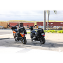 Thrashin Supply Co. Passenger Bag in black ballistic nylon with expandable dual-zipper design and hi-viz orange interior