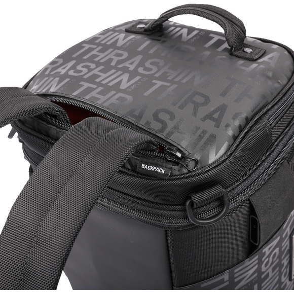 Thrashin Supply Co. Passenger Bag in black ballistic nylon with expandable dual-zipper design and hi-viz orange interior