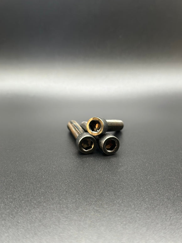 Three ARP stainless steel socket-head hex bolts for Harley-Davidson by Bamco on dark background