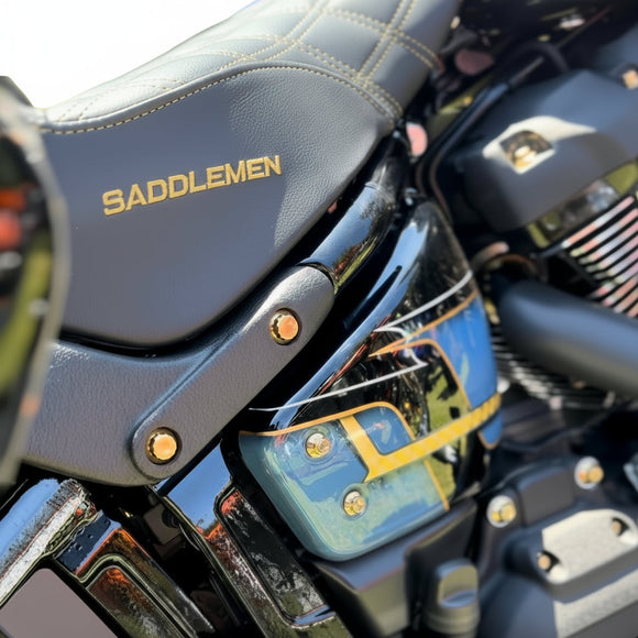 Close-up of Harley-Davidson Softail side showing Bamco ARP stainless steel gold-plated bolts beneath Saddlemen seat