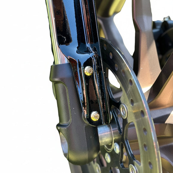 Close-up of two gold Bamco ARP stainless-steel 12-point bolts securing the front fender bracket on a 2020–2023 Harley-Davidson Low Rider S