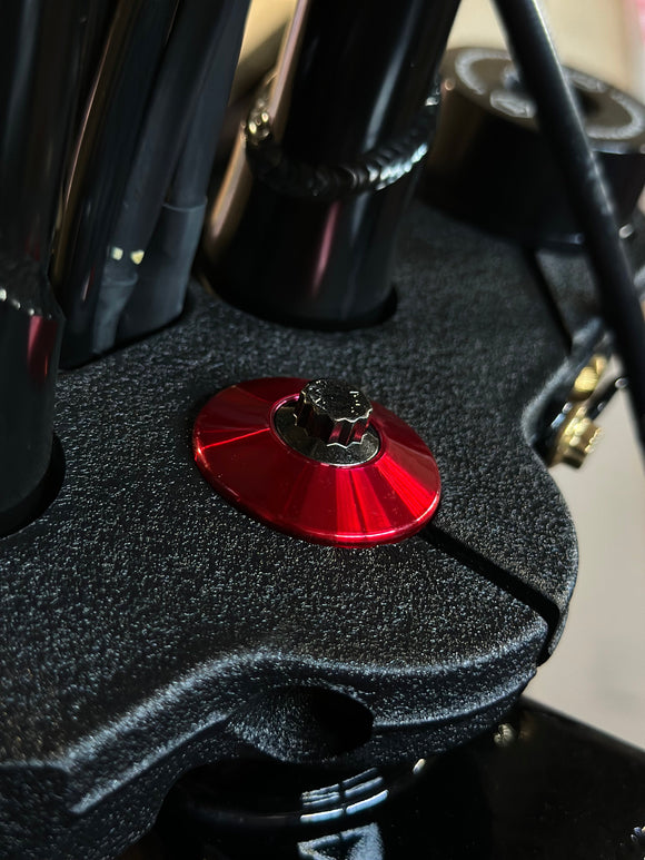 ARP stainless steel bolt for Harley‑Davidson with red Bamco anodized washer on black triple tree