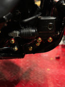 Close-up of BAMCO ARP stainless bolts installed on a Harley-Davidson M8 Softail, M8 Softail Brake Linkage ARP Kit