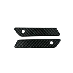 Pair of black slim-line saddle bag latch covers with carbon fiber inserts for 2014–2023 Harley‑Davidson Touring models (Part 104725B)