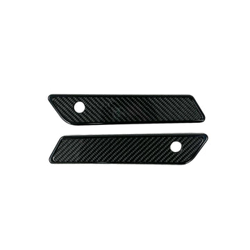 Pair of black slim-line saddle bag latch covers with carbon fiber inserts for 2014–2023 Harley‑Davidson Touring models (Part 104725B)