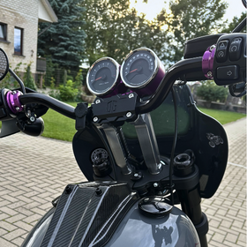 Custom motorcycle handlebar riser with dual analog gauges and purple anodized clamps