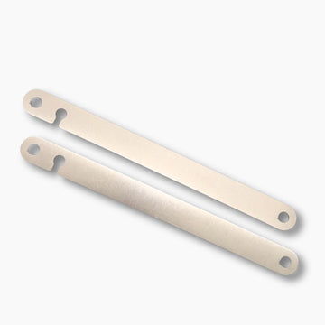 Two dyna strut filler plates with holes on a white background
