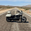 Lowrider ST Motorcycle with a solo tour pack mount for 2 up seats on a desert road with a clear sky.