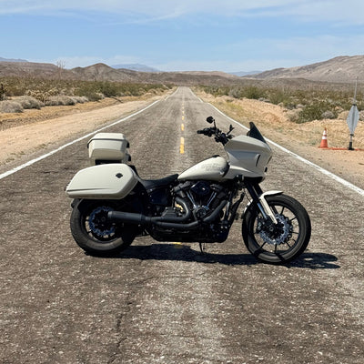 Lowrider ST Motorcycle with a solo tour pack mount for 2 up seats on a desert road with a clear sky.