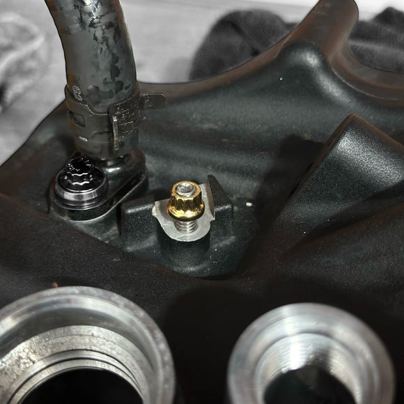 BAMCO ARP gold-plated stainless steel transmission ground stud nut installed on Harley-Davidson 6-speed engine