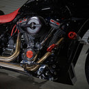 Harley-Davidson bagger crash bar on black motorcycle with chrome engine and gold exhaust