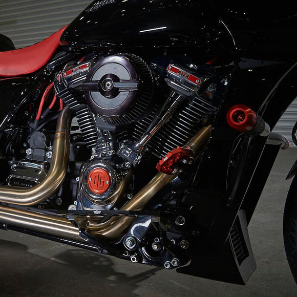 Harley-Davidson bagger crash bar on black motorcycle with chrome engine and gold exhaust