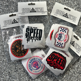 Collection of Speed Kings stickers in packaging on a gray surface