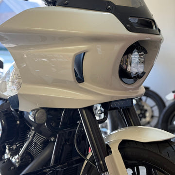 Close-up of a Low Rider ST motorcycle's Baja lp4 front headlight and light bar aux light