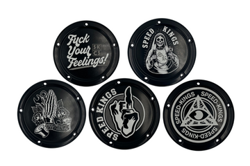 A collection of custom-designed derby covers for M8 Softail Harley Davidson Motorcycles, each with a unique black and white graphic, attached to a white background for display by Speed Kings