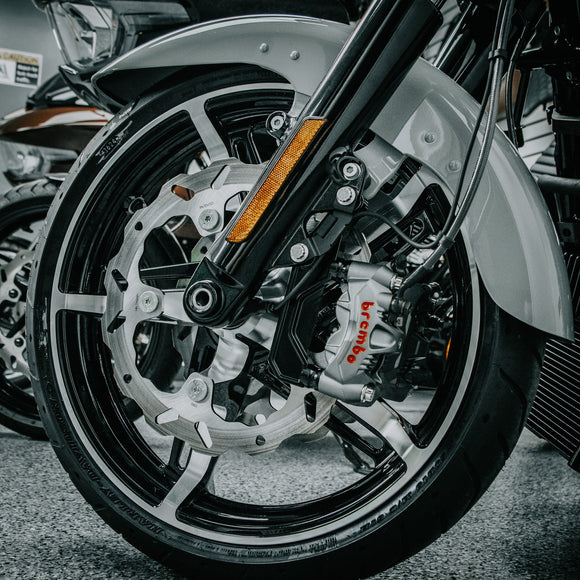 Close-up of OG Moto 320mm Complete Radial Brake Kit installed on a 2024-Up Harley-Davidson Touring motorcycle, showing the solid mount wave rotor, Brembo radial caliper, and CNC-machined radial bracket on the front wheel.