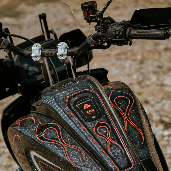 Pan America pull-back handlebar risers on motorcycle with black metallic-flake tank and red pinstripe flames