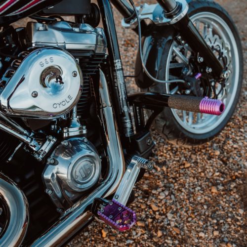 HoneyComp V3 Mini M8 motorcycle footpeg on Harley Softail — purple anodized