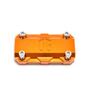 Orange anodized OG handlebar riser top clamp with four hex bolts