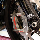 Brembo motorcycle front brake caliper on Ohlins fork