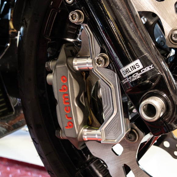 Brembo motorcycle front brake caliper on Ohlins fork