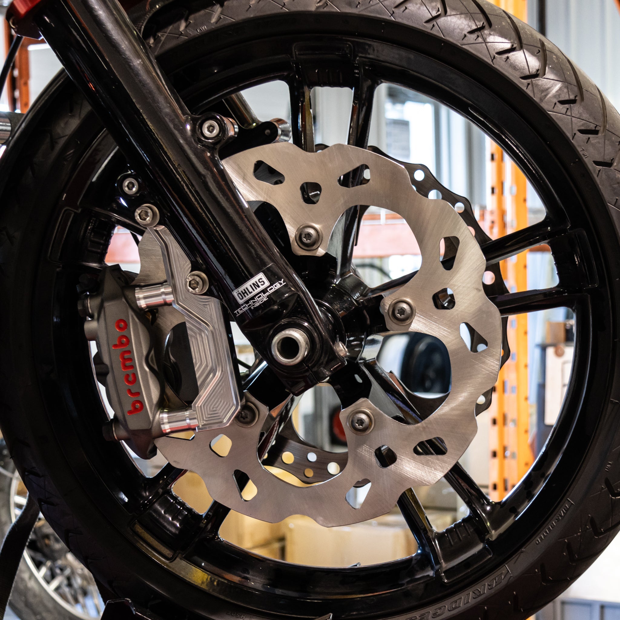 Motorcycle front wheel with Brembo brake caliper and wave brake rotor