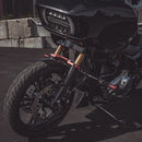 Black bagger motorcycle front with red fork clamps and LED headlight