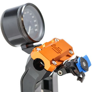 Orange anodized Quad Lock motorcycle handlebar phone mount with gauge bracket