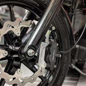 Original Garage Moto OG radial-mount brake caliper bracket mounted on motorcycle front wheel