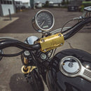 OG single-gauge pod gold handlebar mount with speedometer on black motorcycle