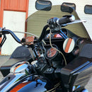 Motorcycle handlebar risers on black touring bike with windshield and gauges