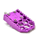 Purple anodized aluminum motorcycle foot peg with serrated grip and hexagon cutouts
