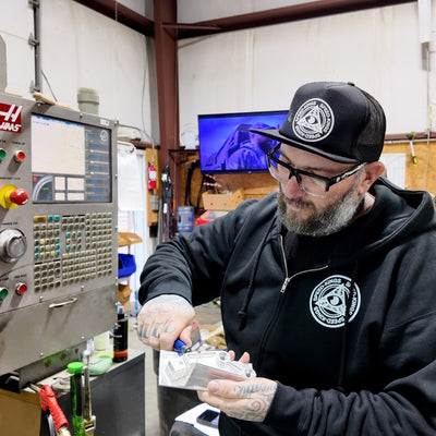 Steve from Speed Kins rocking the SKC Zip Hoodie in Black operating the Haas CNC