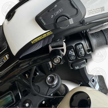 Motorcycle helmet with a Cardo communication device attached hooked to a Lid Locker Helmet Lock