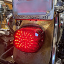 Red LED integrated Dyna tail light on a motorcycle with 'Harley-Davidson' branding.