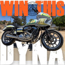 A custom silver and black motorcycle with lime green accents, set against a desert background with large orange and white text overlays reading 'WIN THIS DYNA'.