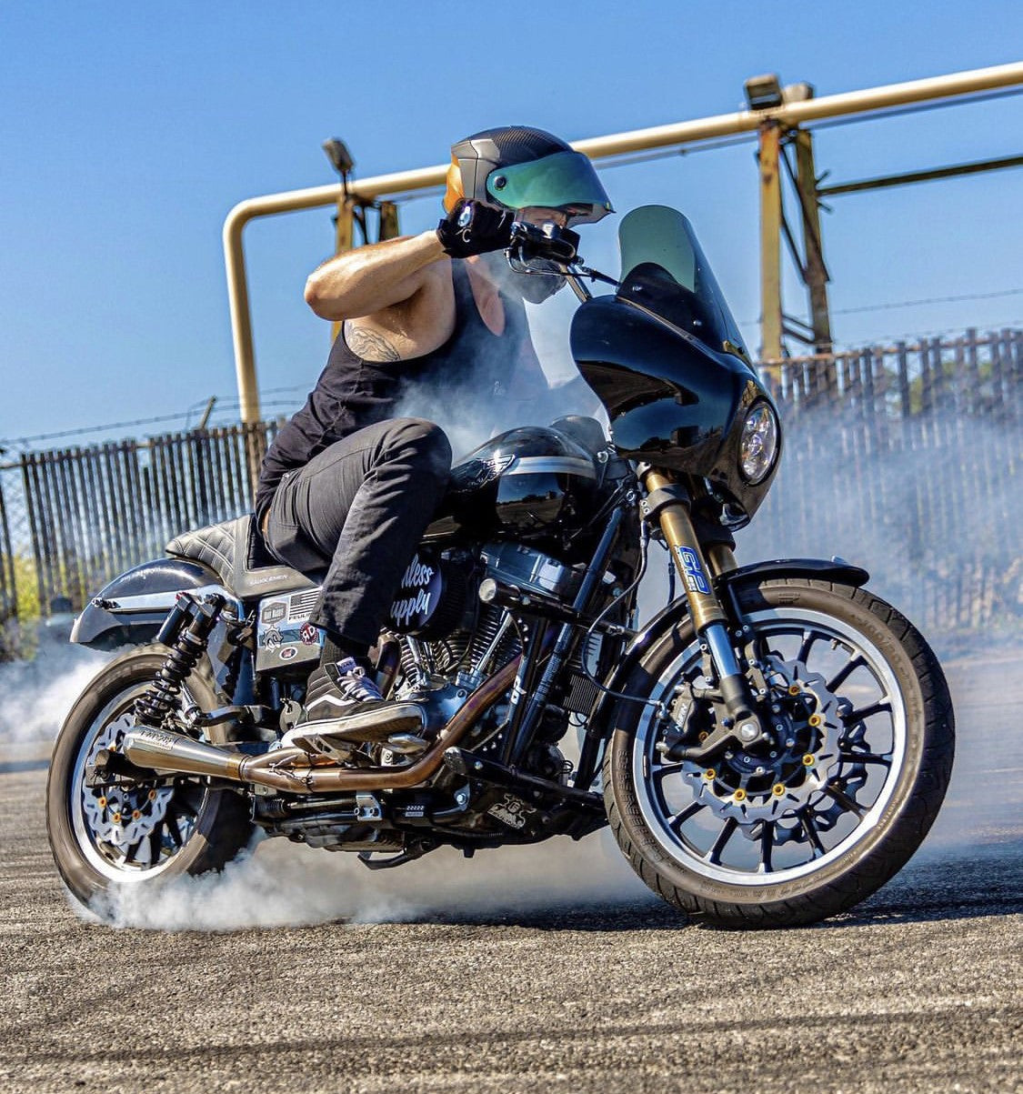 RWD V-Twin TXR fairing windscreen replacement on black Harley-style motorcycle with rider doing burnout